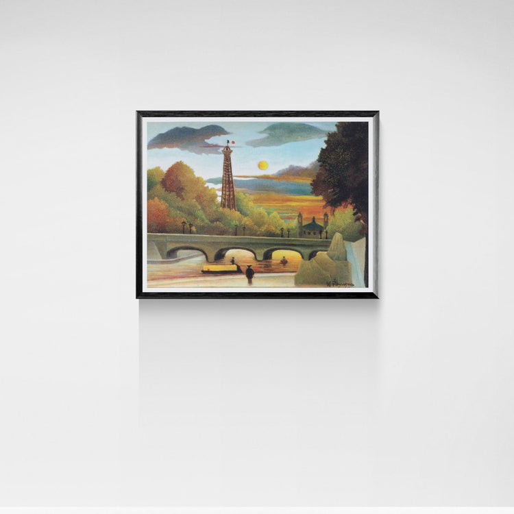 Framed artwork of a Paris landscape with a bridge and trees on a white wall.