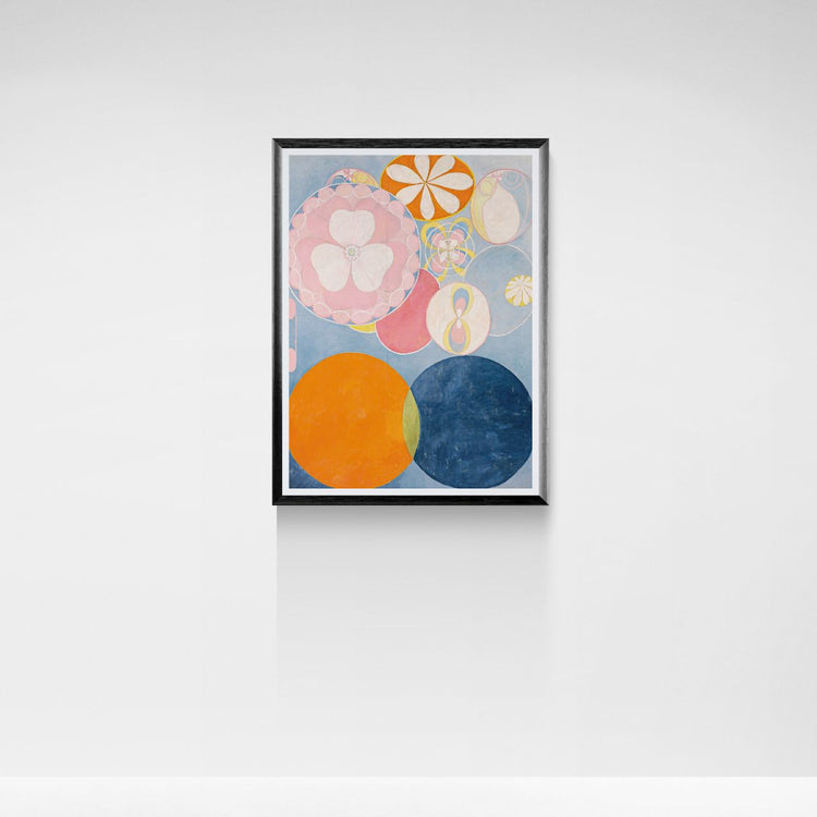 Framed abstract artwork with colorful circles on a white wall