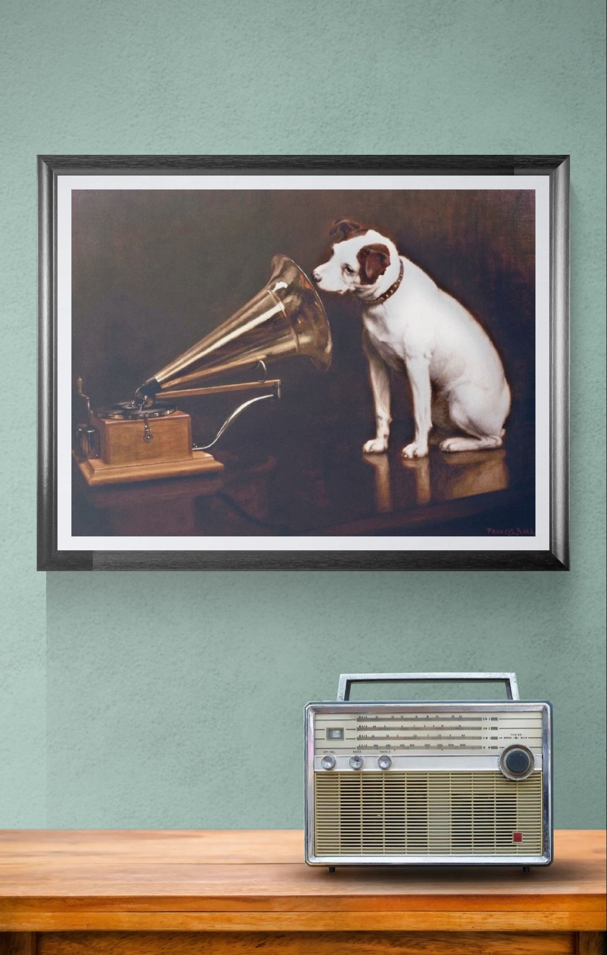 Framed artwork of a dog listening to a gramophone on a wall above a wooden surface with a radio.