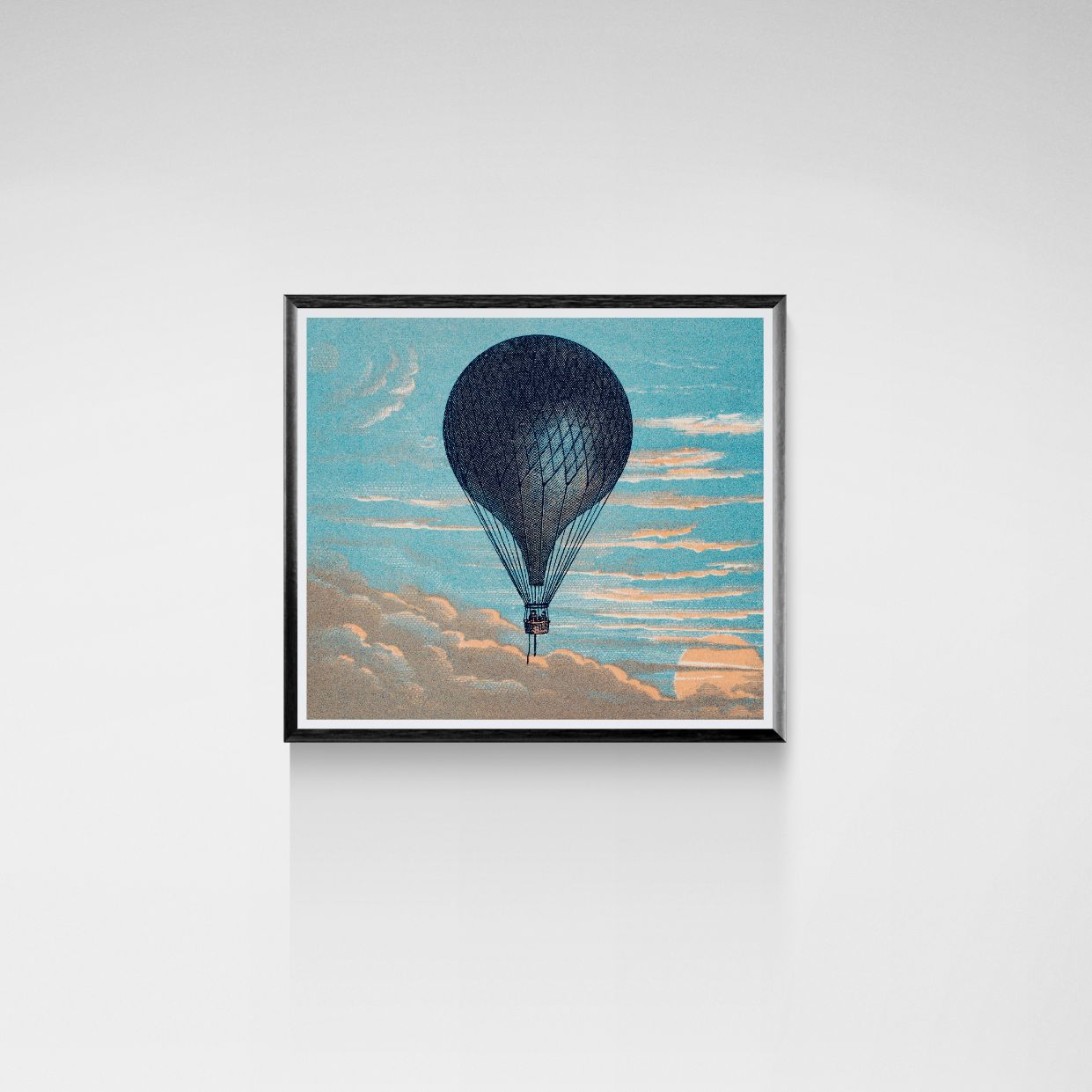 Framed artwork of a hot air balloon in the sky with clouds.