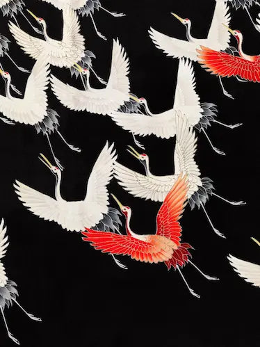 High-quality Giclée reproduction of a Japanese Furisode textile pattern featuring a myriad of flying cranes (tsuru), predominantly white with black accents and a few dramatic red-winged cranes, set against a solid black background, vintage 1900s.