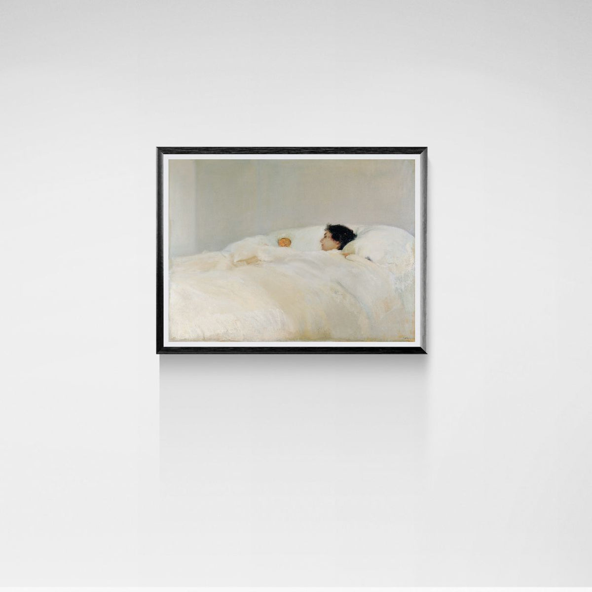 Framed artwork of a person lying on a bed with a white blanket against a light gray wall.