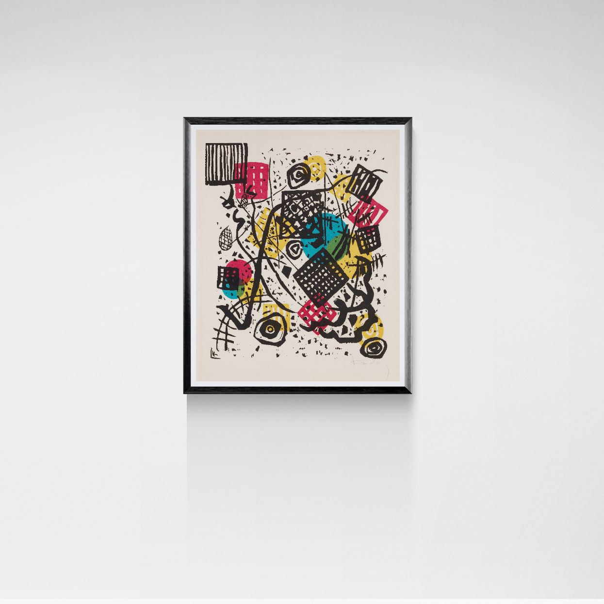 Framed abstract artwork with colorful design on a white wall
