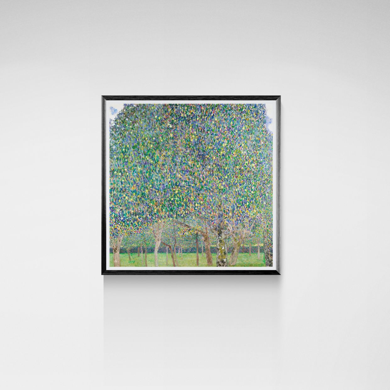 Framed artwork of a forest scene with trees and flowers on a white wall.