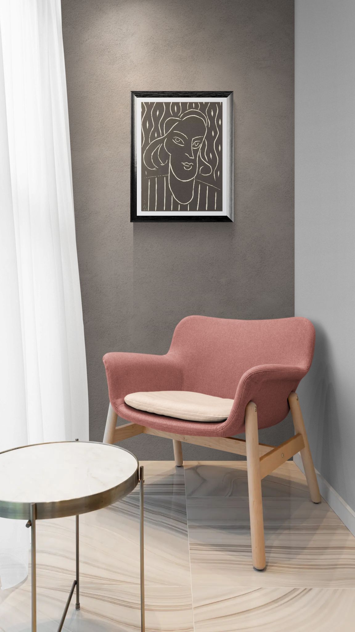 Pink armchair with a beige cushion in a room with a framed artwork on the wall.