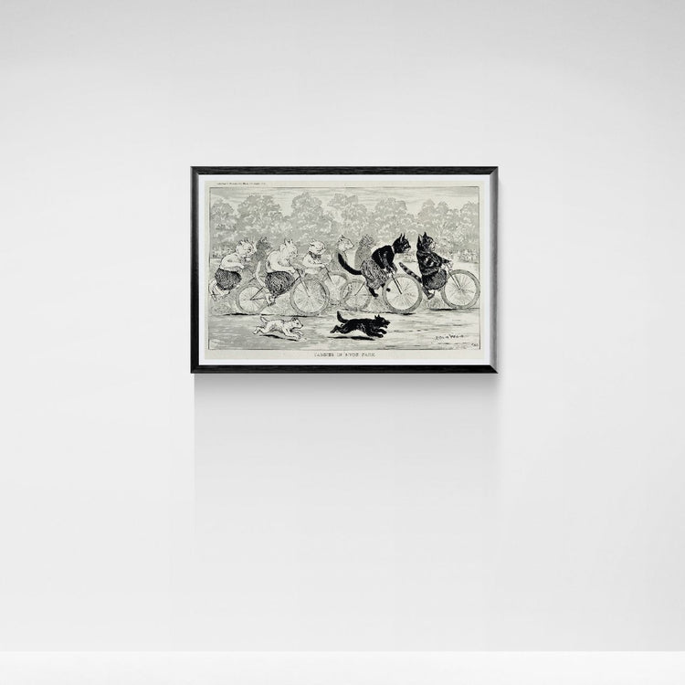 Framed black and white print of a vintage cats illustration on a white wall