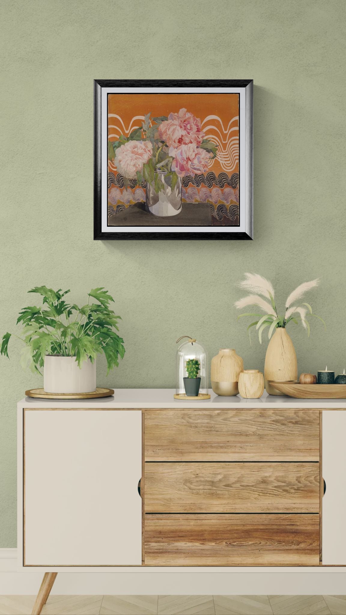 Framed artwork on a wall above a wooden cabinet with decorative items.