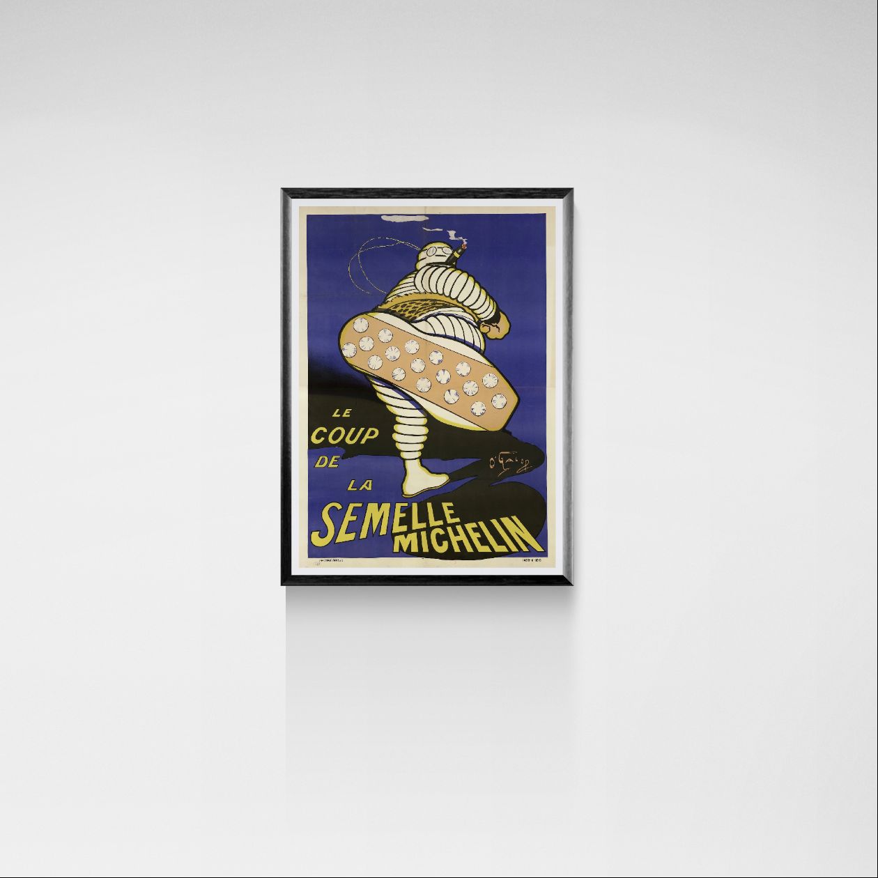 Framed poster of Michelin tire advertisement on a white wall