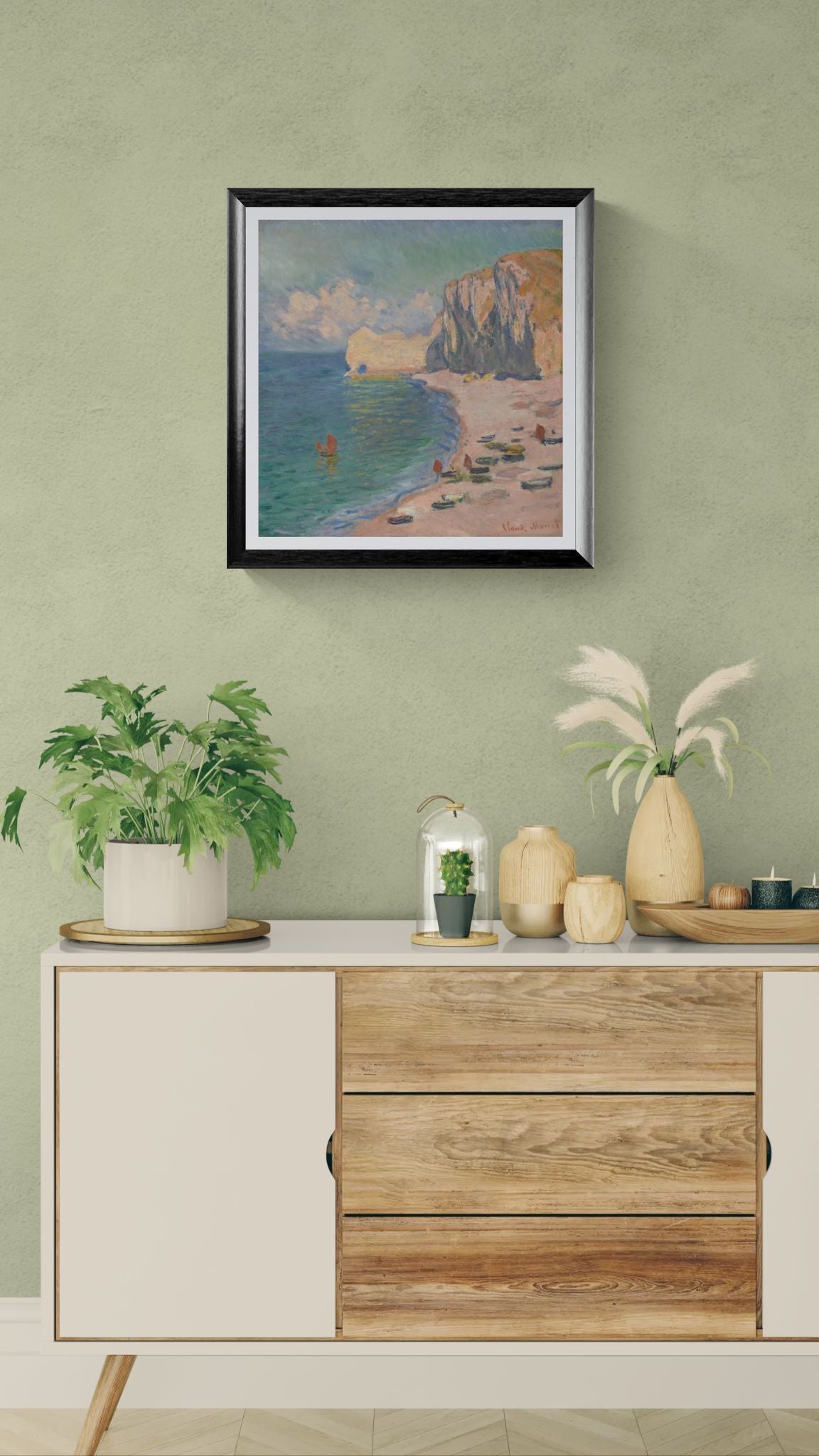 Framed artwork on a wall above a wooden cabinet with decorative items.
