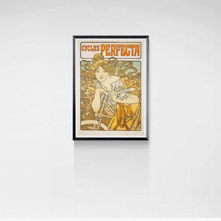 Framed vintage-style poster of a woman with 'Cycles Perfecta' text on a white wall.