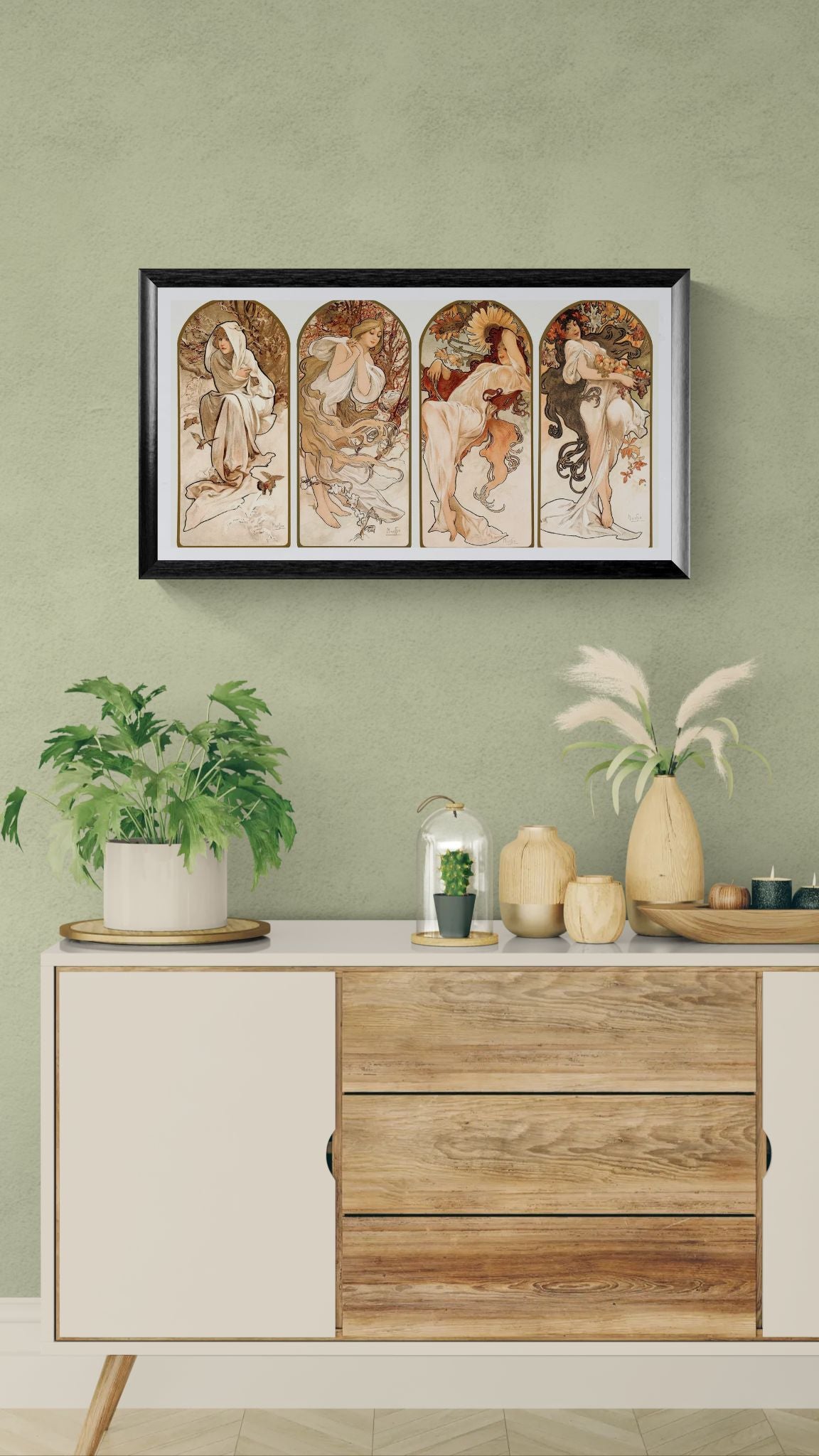Framed artwork on a wall above a wooden cabinet with decorative items.