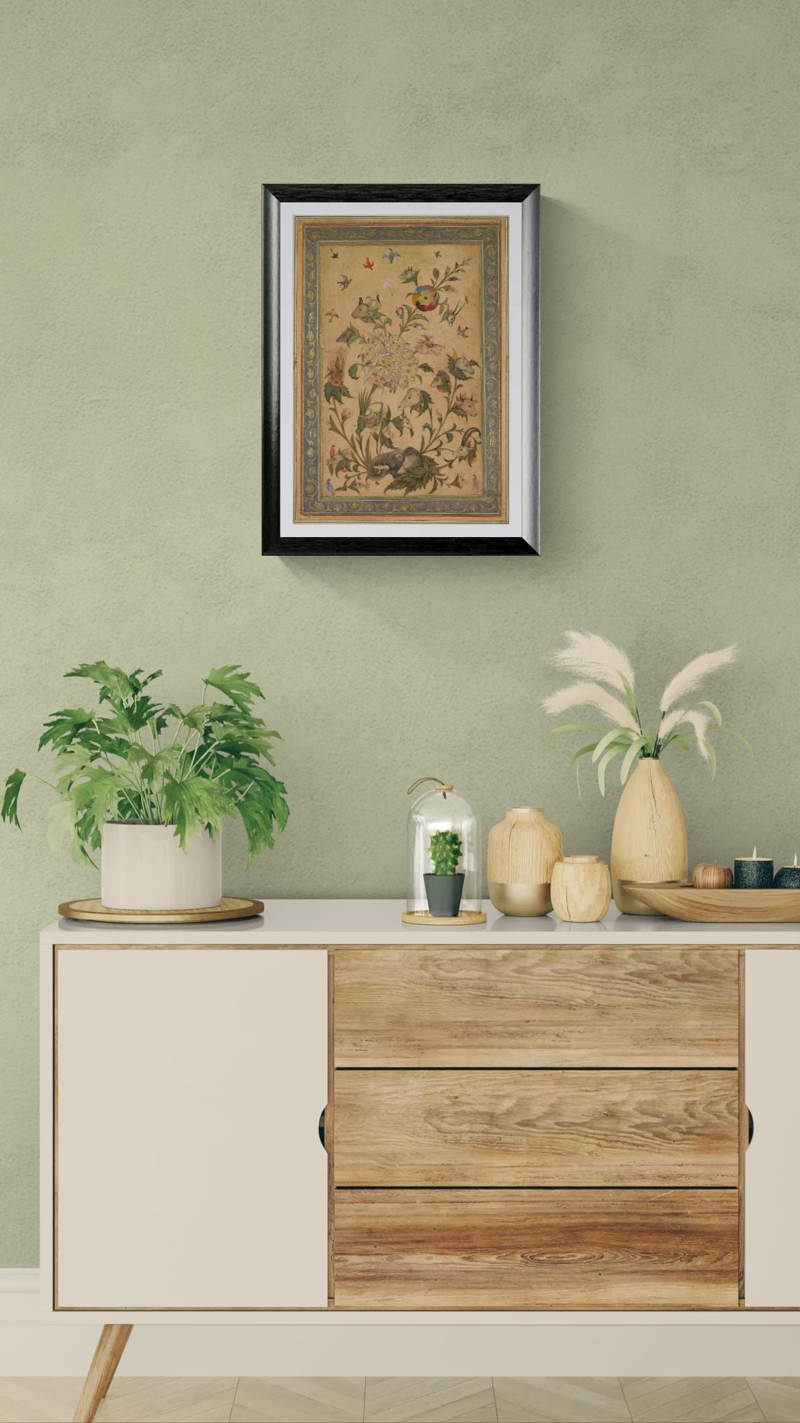 Wooden sideboard with decorative items against a green wall with a framed picture.