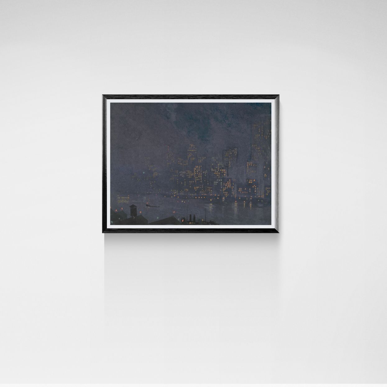 Framed artwork of a cityscape at night on a white wall