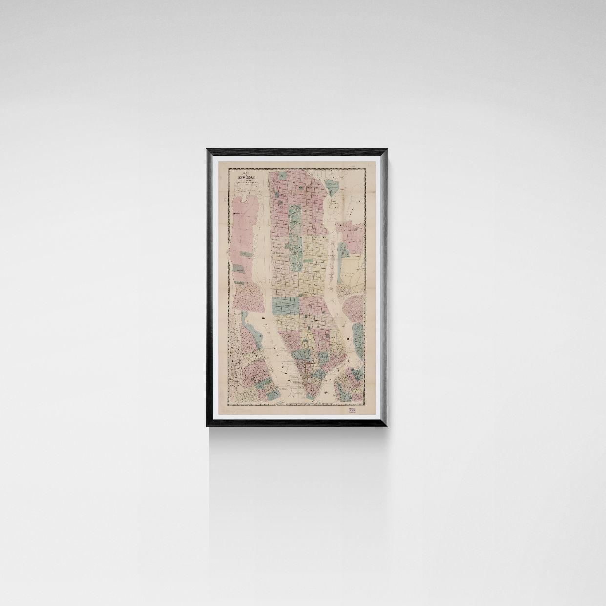 Framed vintage map of New York City on a white wall