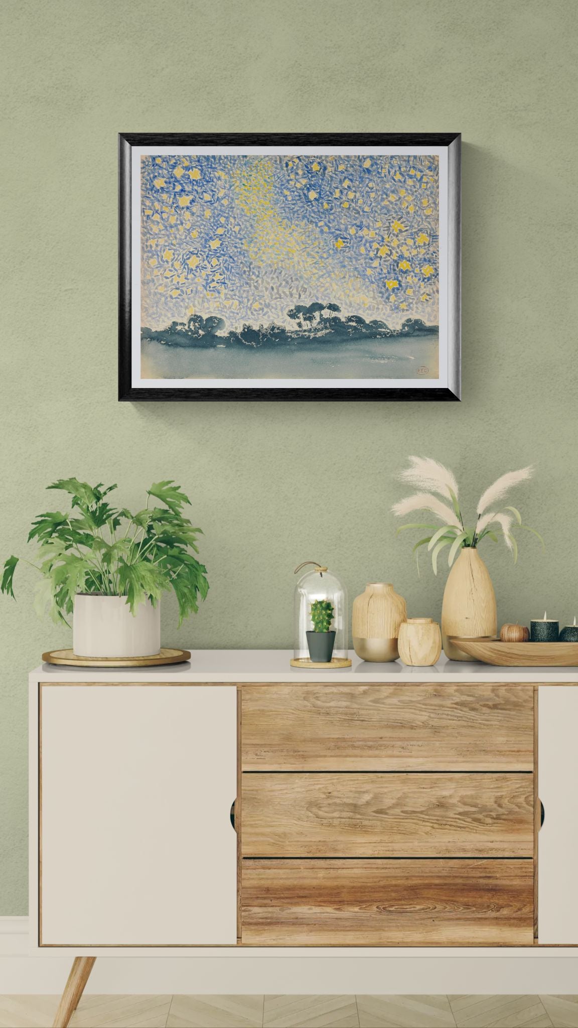 Framed artwork above a wooden cabinet with decorative items on a green wall.