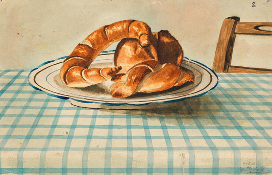 Three croissants on a plate with a checkered tablecloth