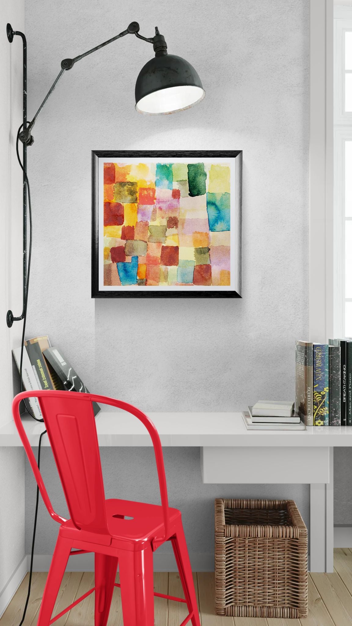 Colorful abstract art on a wall above a desk with a red chair.