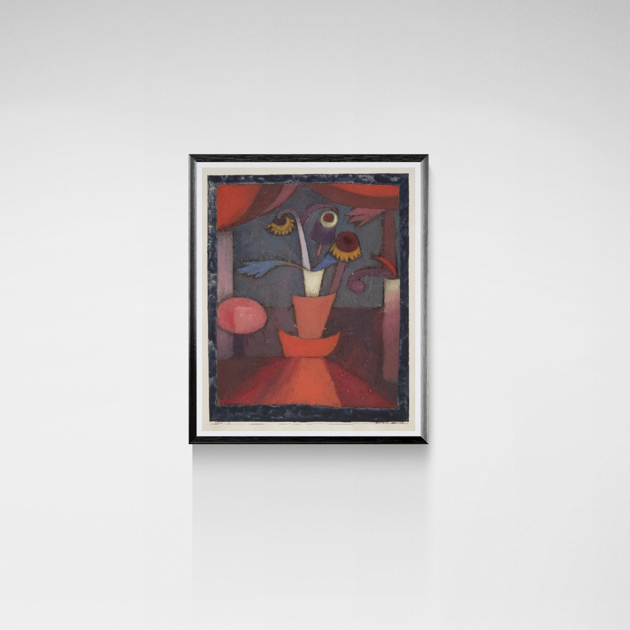 Framed abstract painting on a white wall