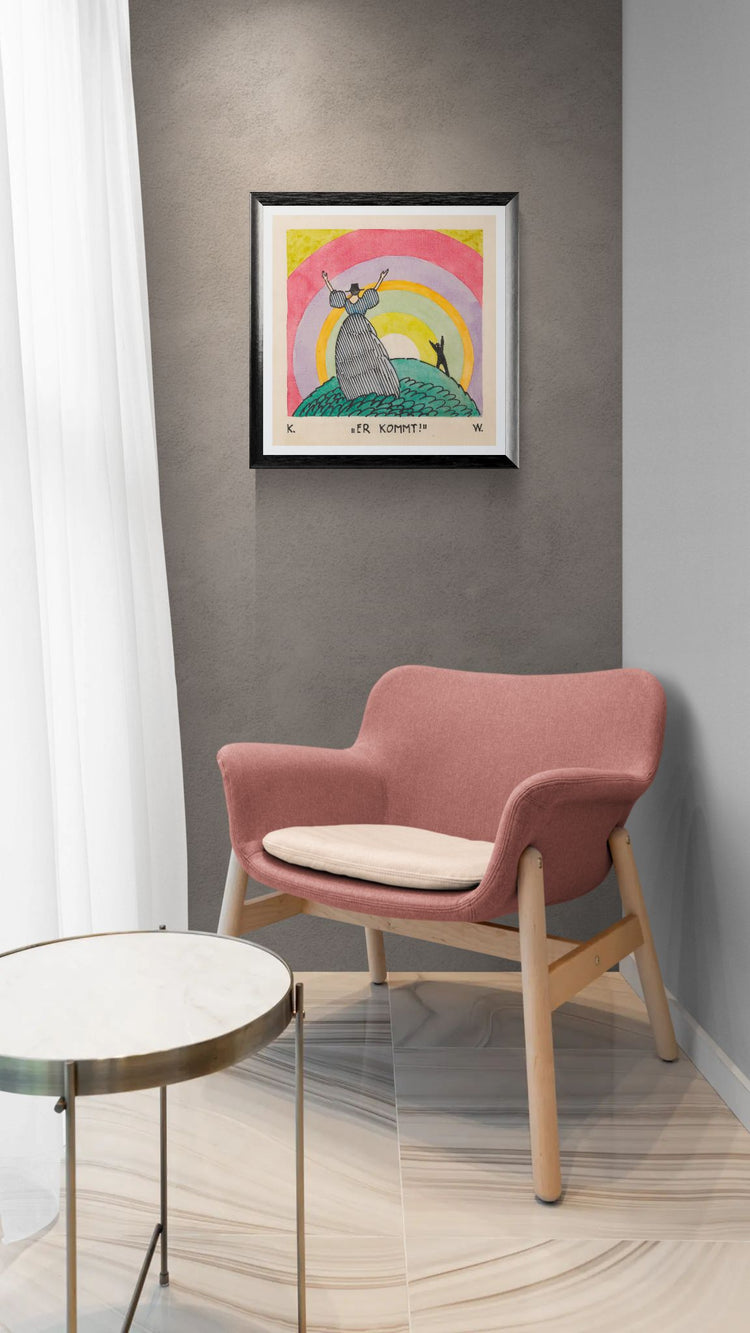 Pink armchair in a room with a colorful framed picture on the wall.