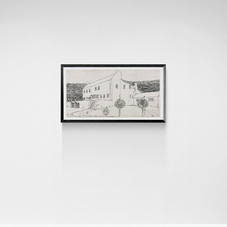 Framed black and white drawing of a building on a white wall