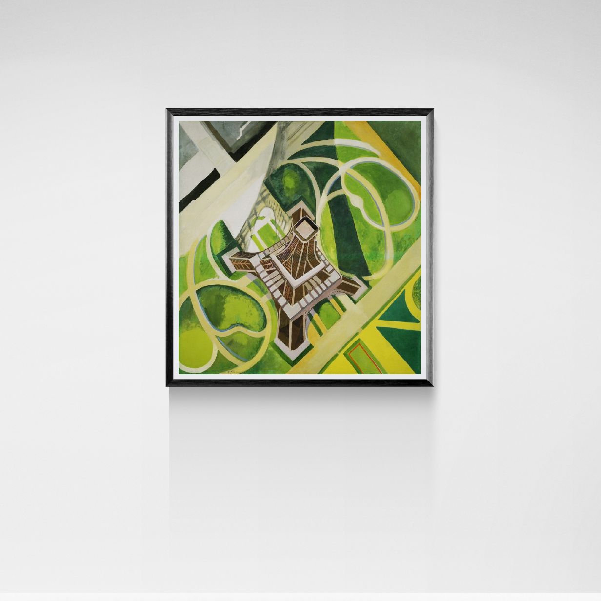 Framed abstract artwork with green and yellow colors on a white wall