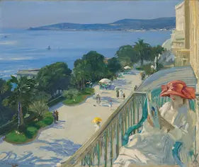 High-quality Giclée reproduction of Sir John Lavery's Impressionist painting 'The Terrace, Cap-d'Ail,' showing a woman in a white coat and red hat reading on a sunny balcony overlooking the blue French Riviera and the sea, vintage 1925.