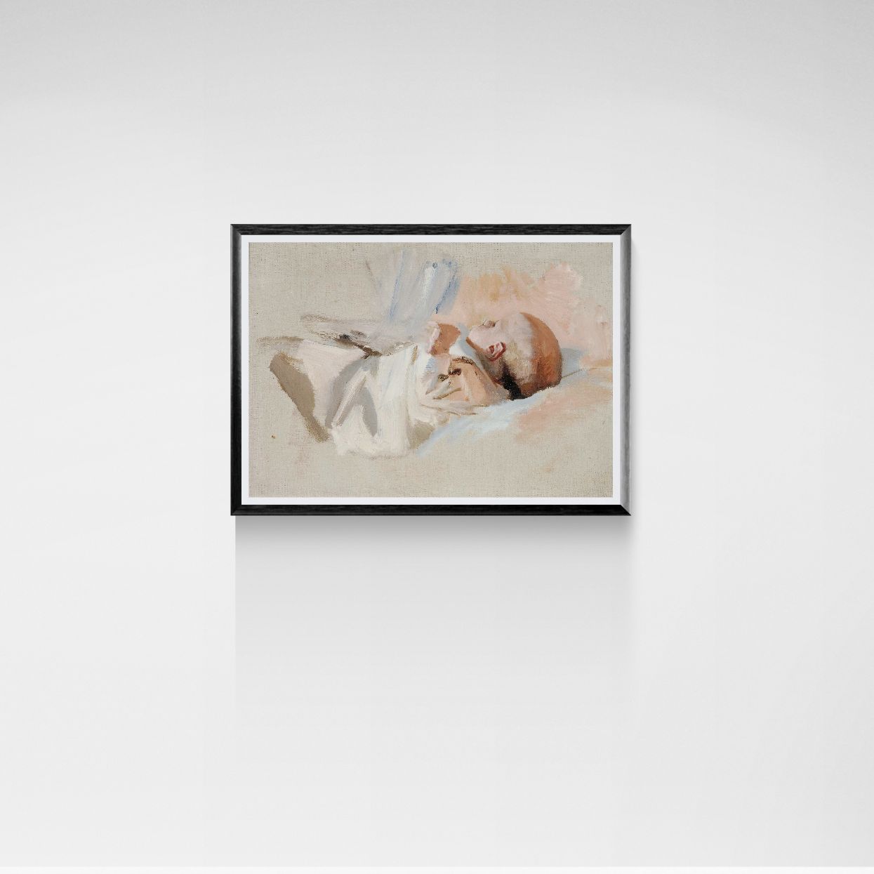 Framed artwork of a baby lying on a bed with a white pillow and blue bow.