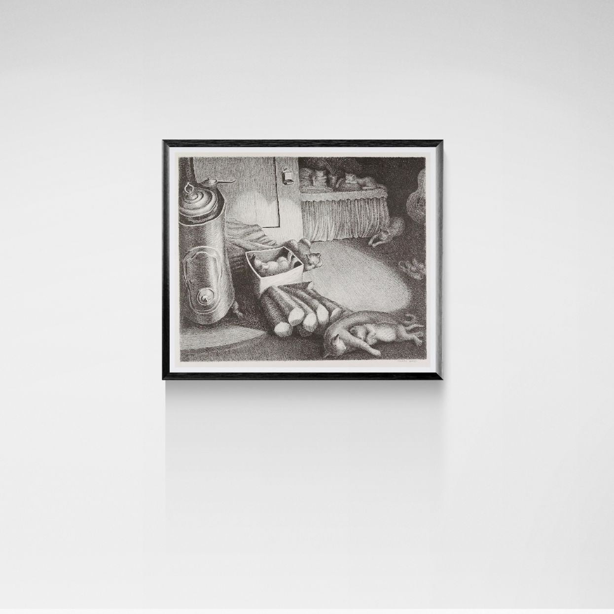 Framed black and white sleeping cats artwork on a white wall