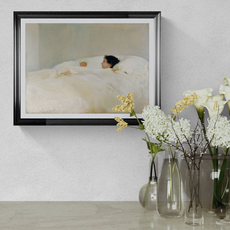 Framed artwork of a woman lying on a bed with flowers in the foreground