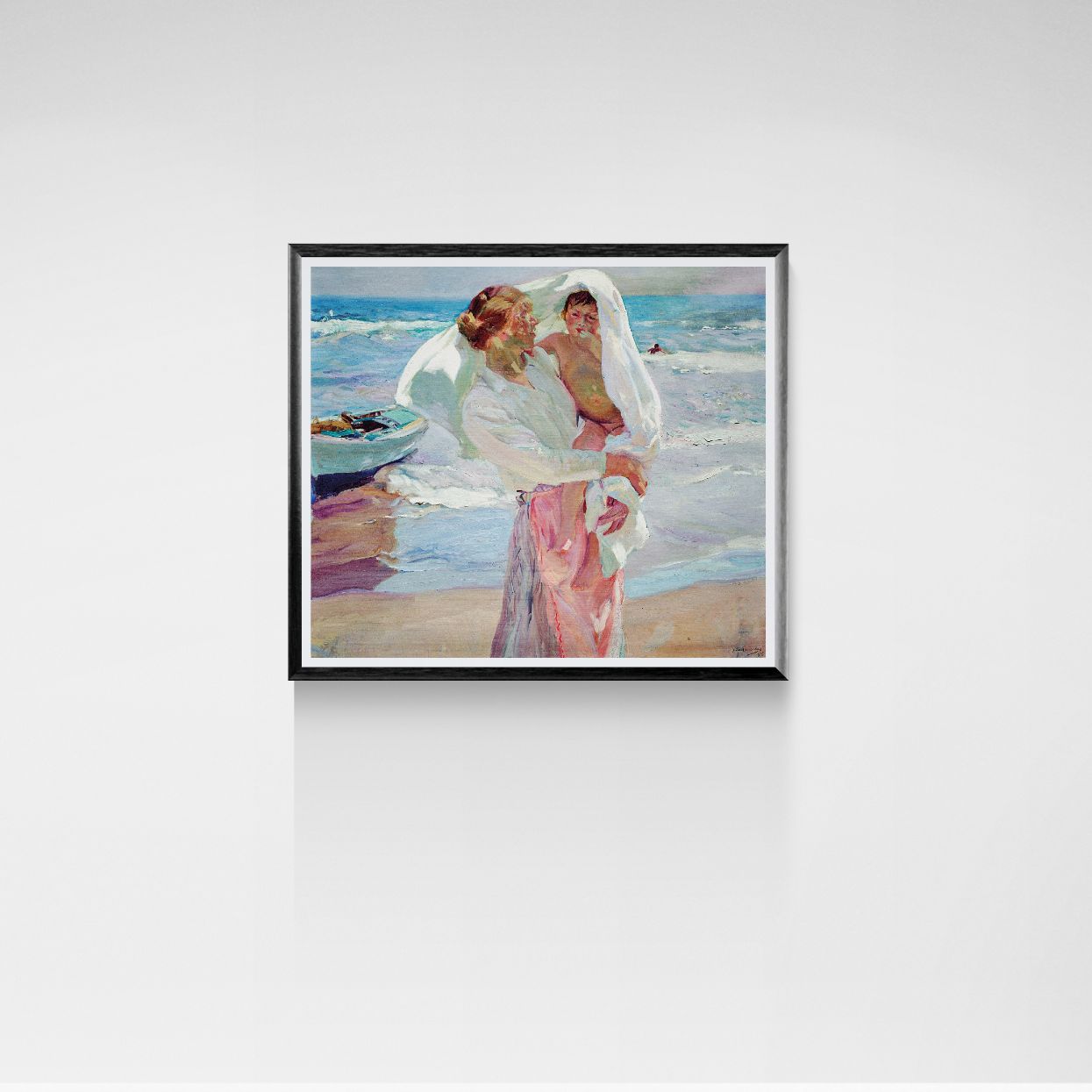 Framed artwork of a couple on a beach with a boat in the background.