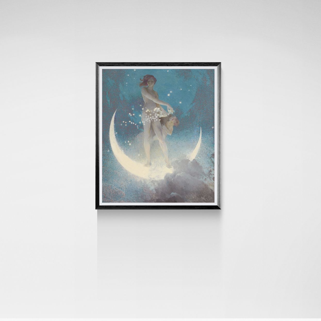 Framed artwork of two figures on a crescent moon against a starry sky, on a white wall.
