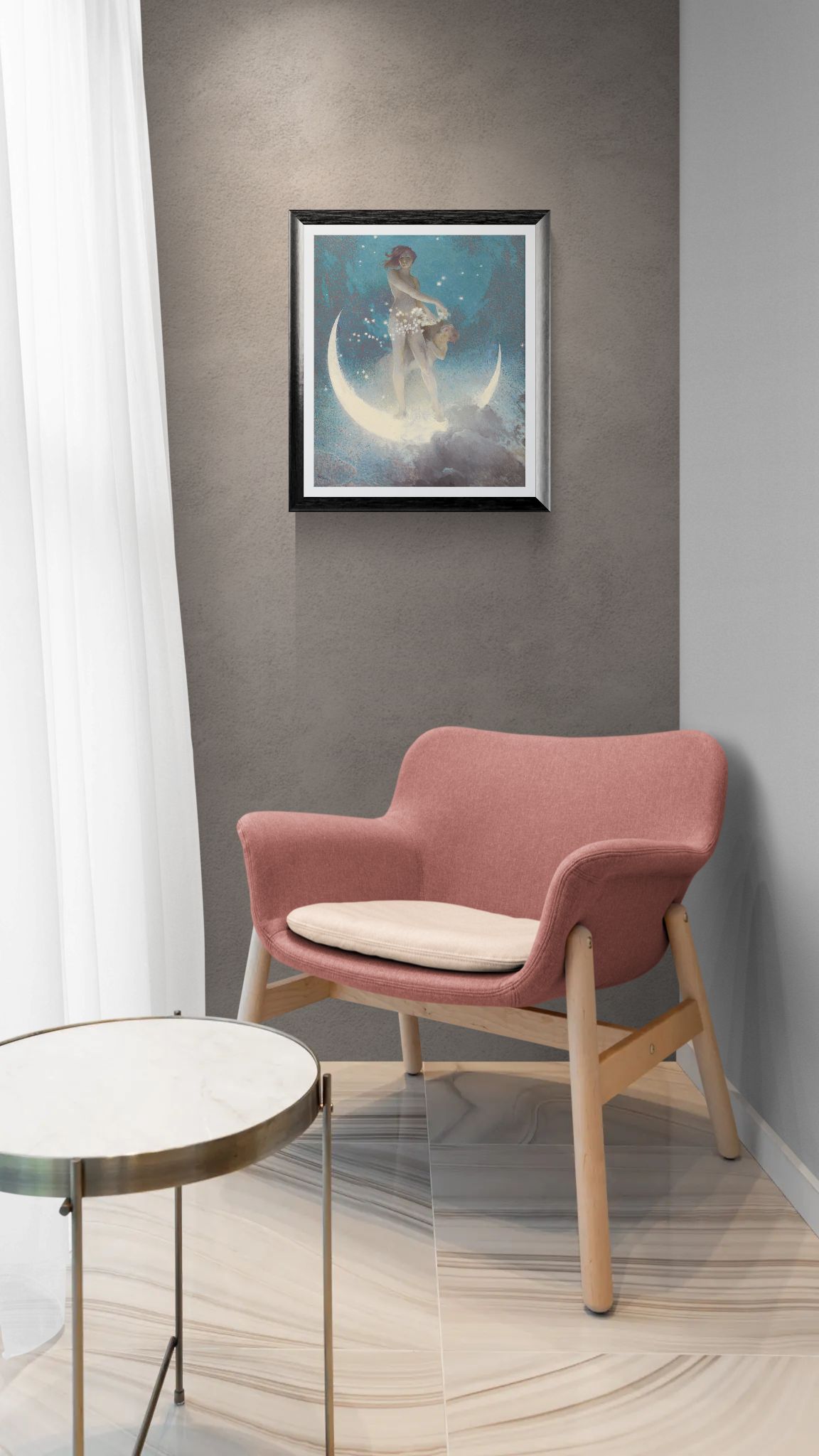 Pink armchair with a small table against a gray wall with a framed picture.