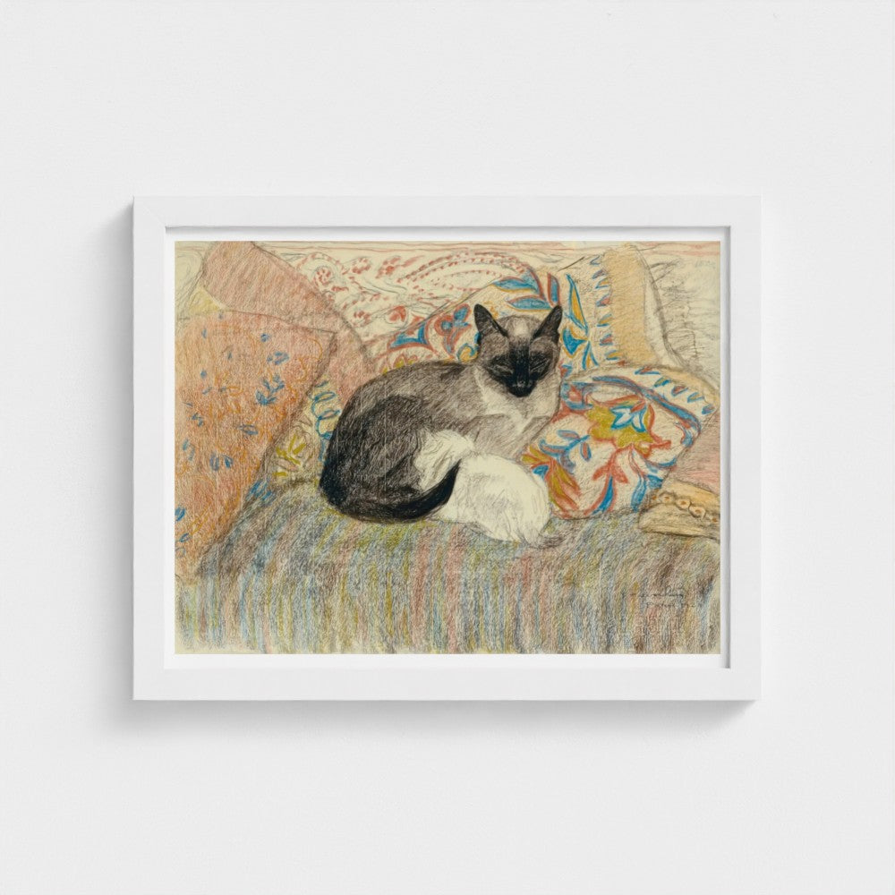 Framed artwork of a cat sitting on a patterned chair
