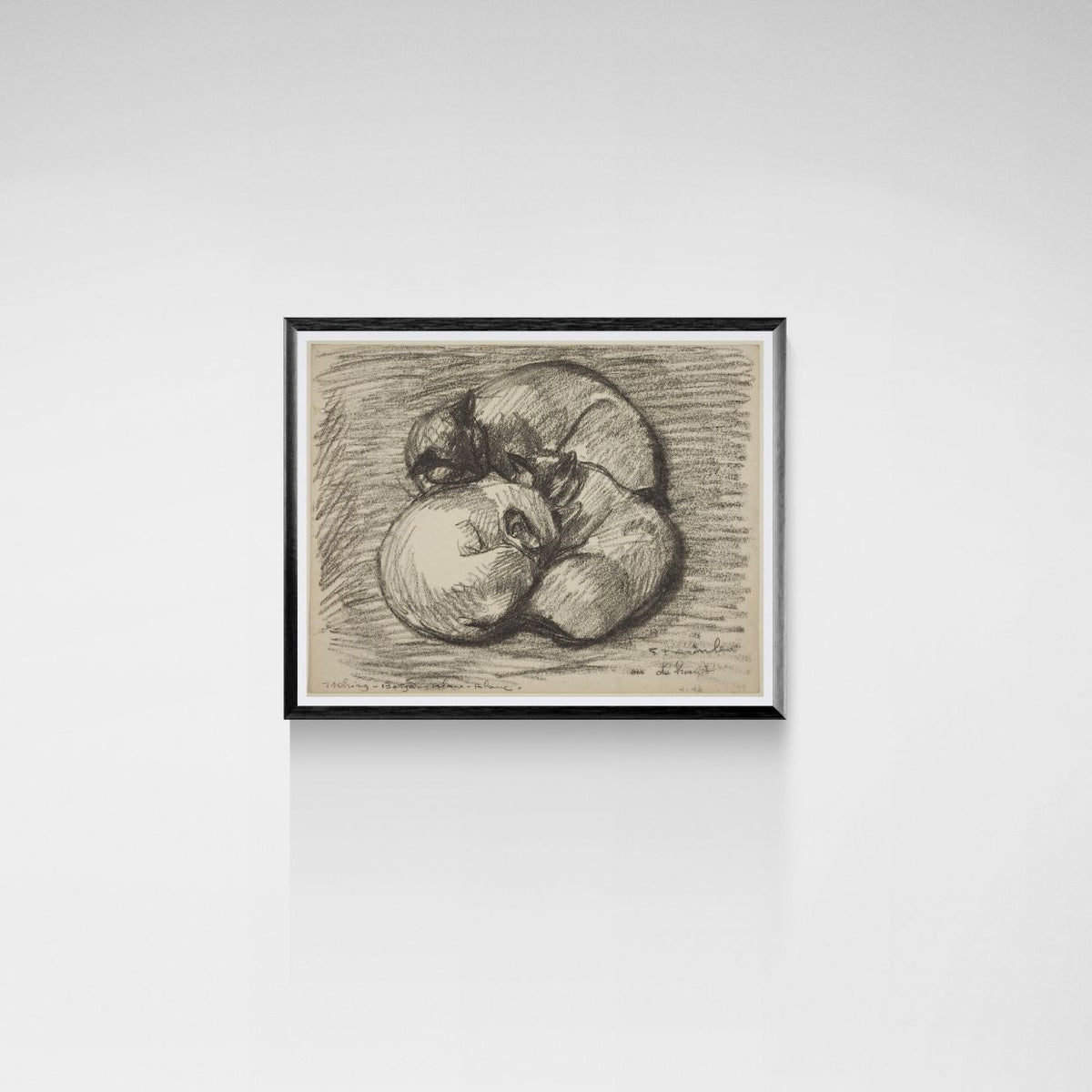 Framed black and white drawing of three cats on a white wall