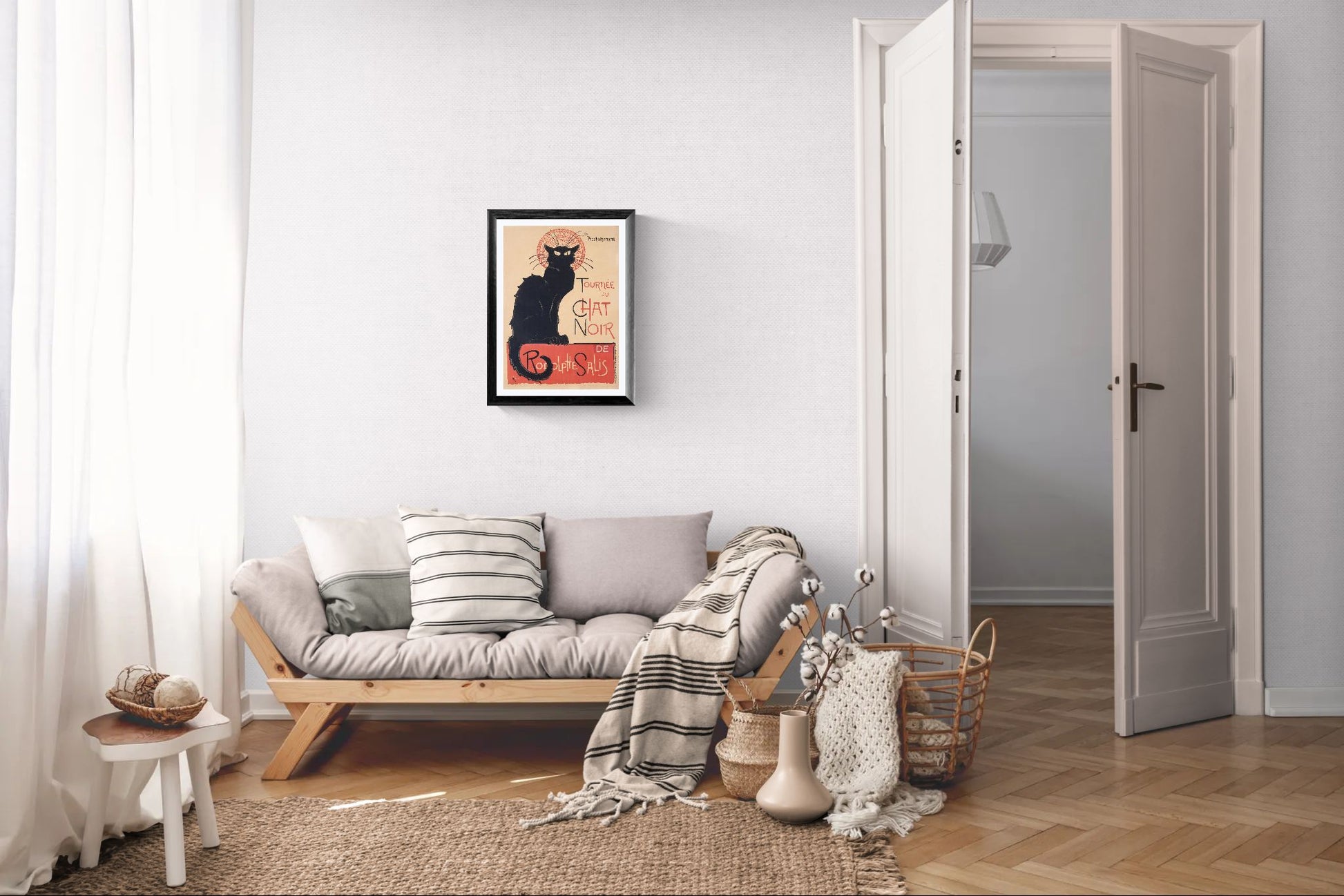 Living room with a sofa, cushions, and a framed picture on the wall.
