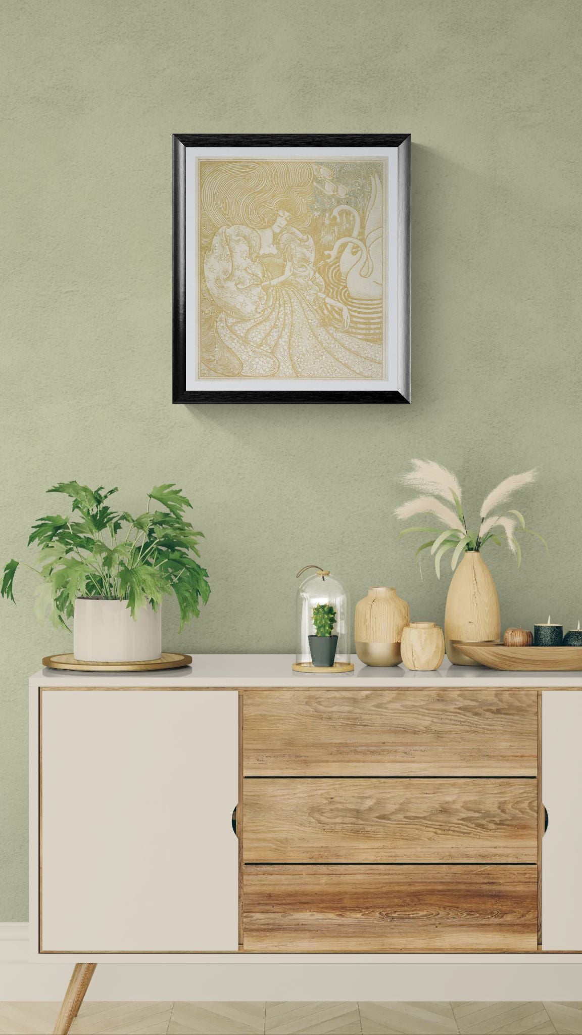 Decorative setup with a framed artwork, plants, and vases on a wooden cabinet against a green wall.