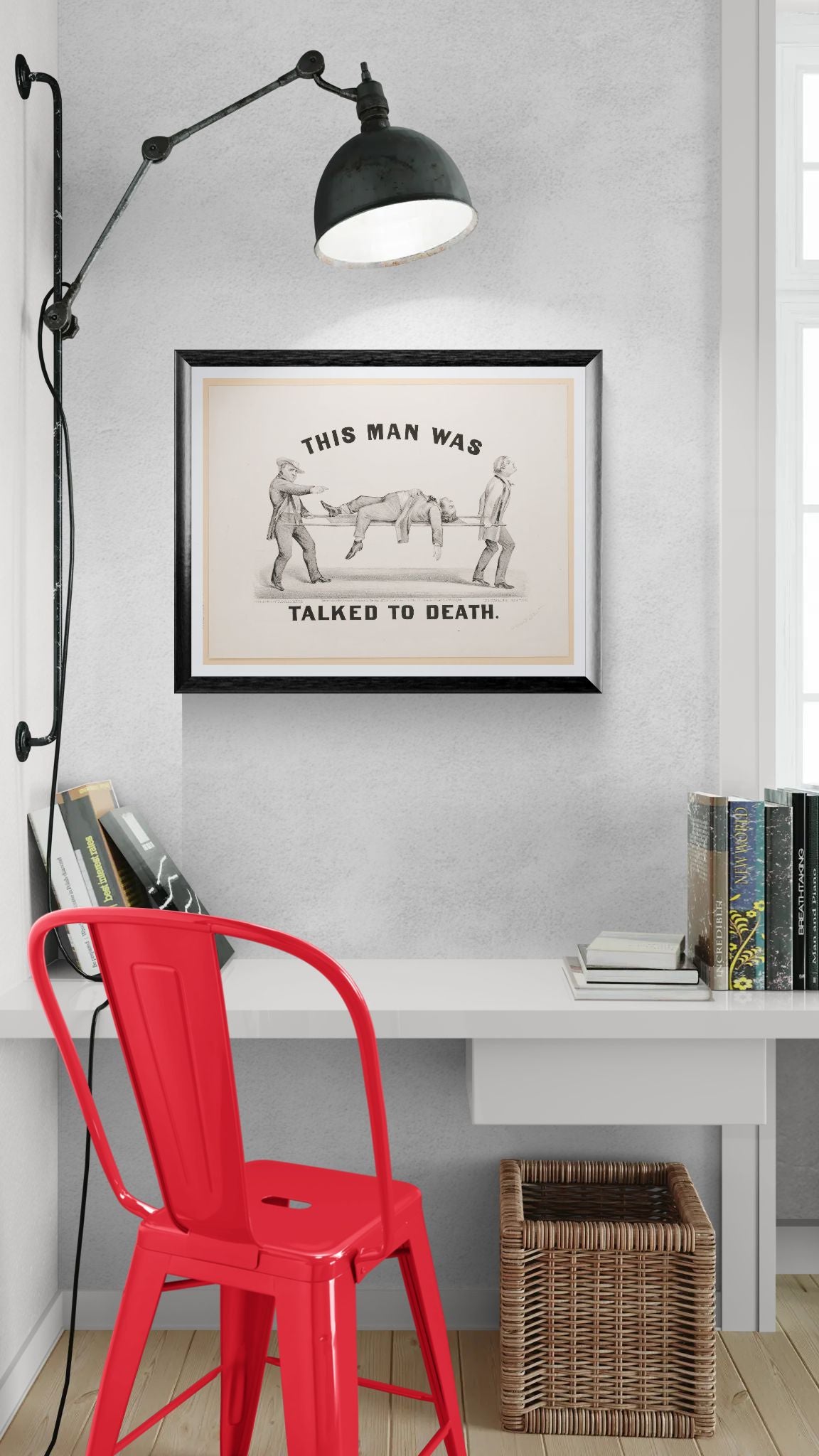 Modern office setup with a red chair, white desk, and framed artwork on a gray wall.