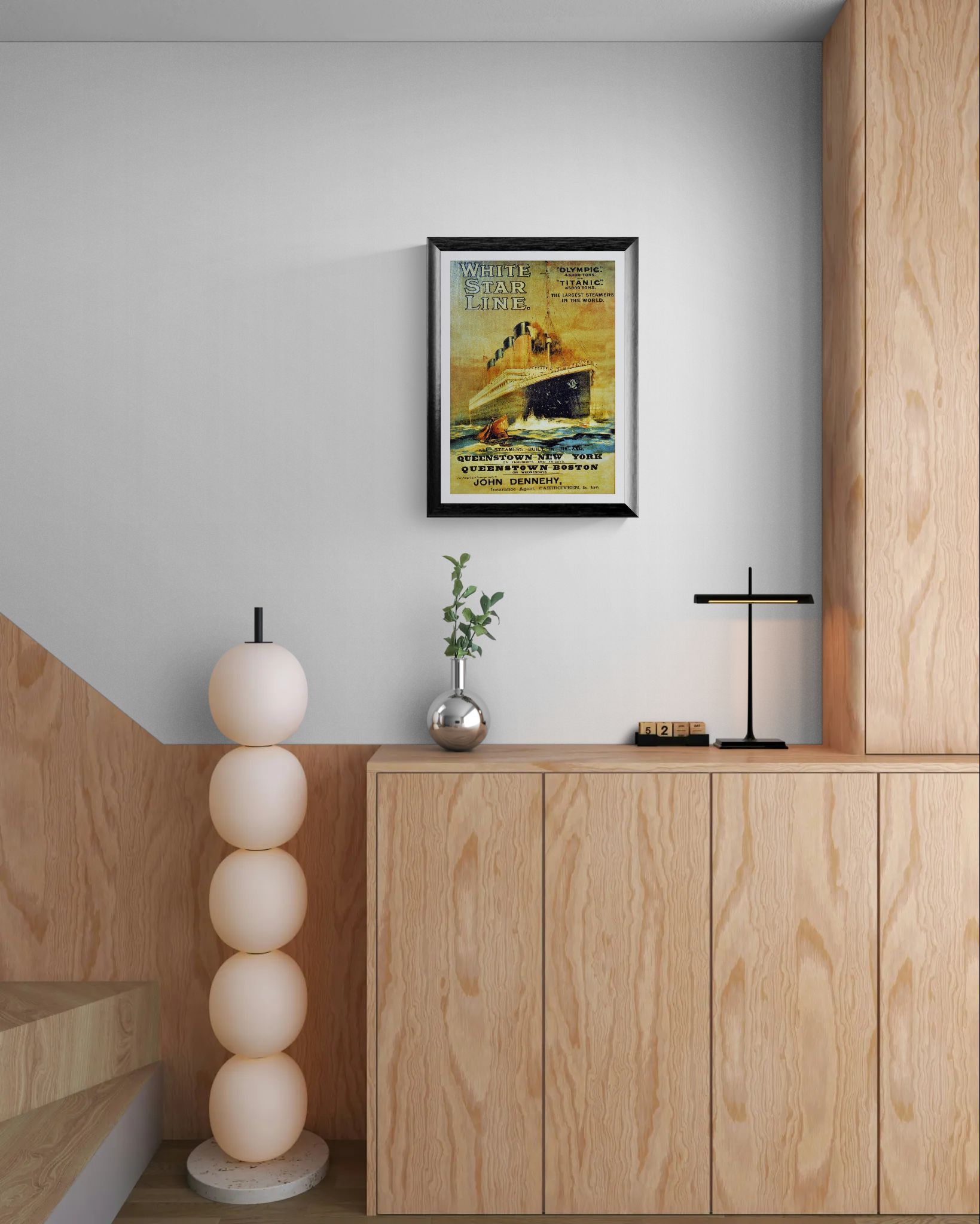 Framed poster on a wall above a wooden cabinet with decorative items.