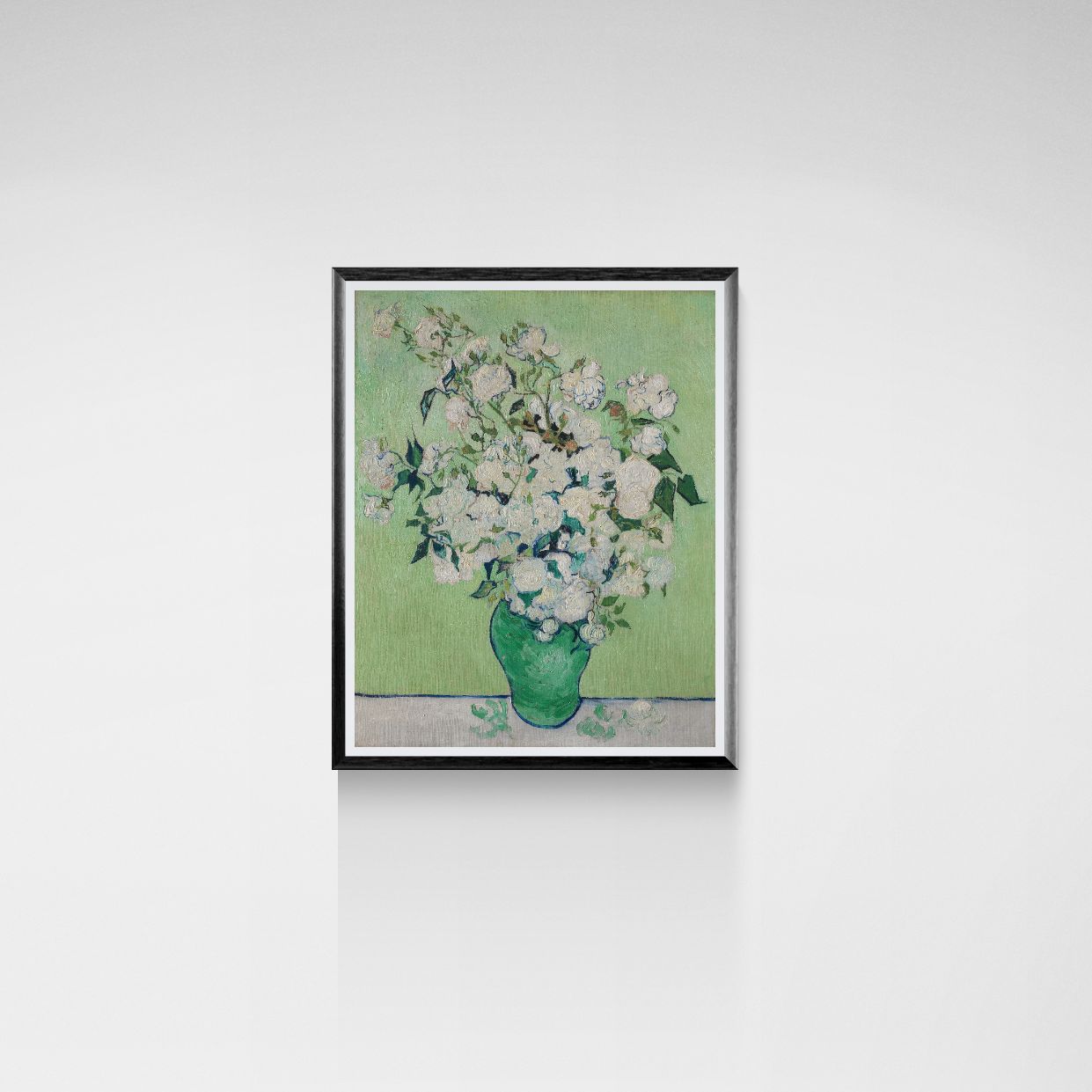 Framed artwork of a vase with flowers on a white wall