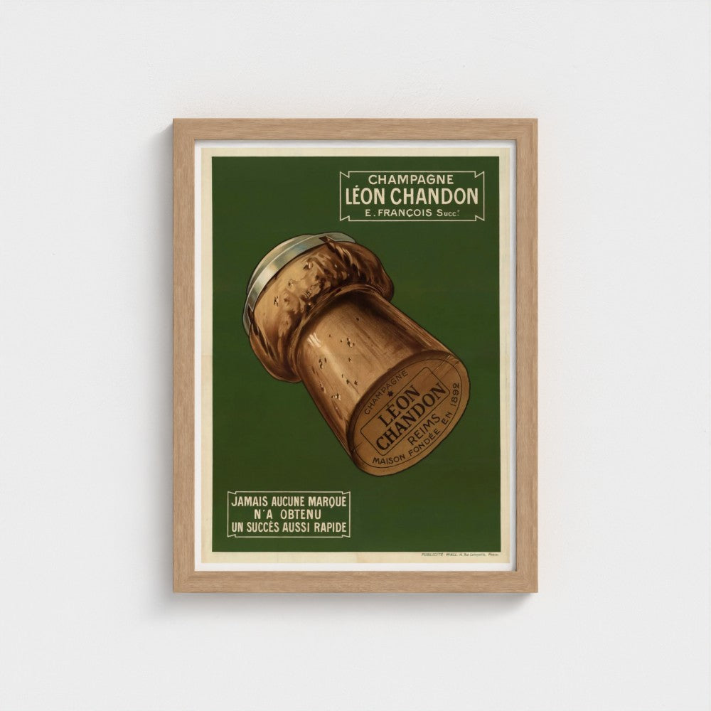 Framed poster of a champagne cork with 'Leon Chandon' branding on a green background.