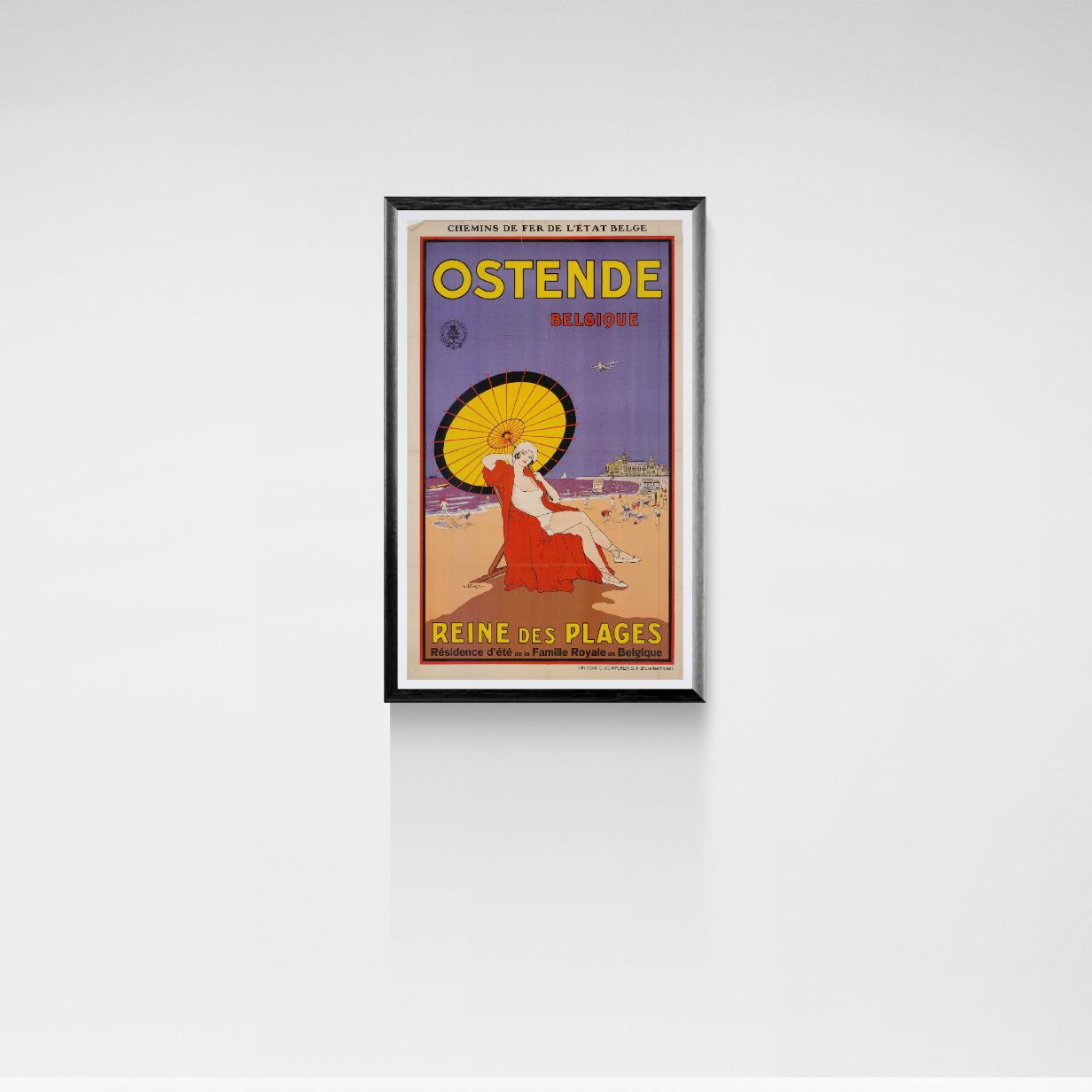 Framed vintage travel poster for Ostende, Belgium on a white wall.