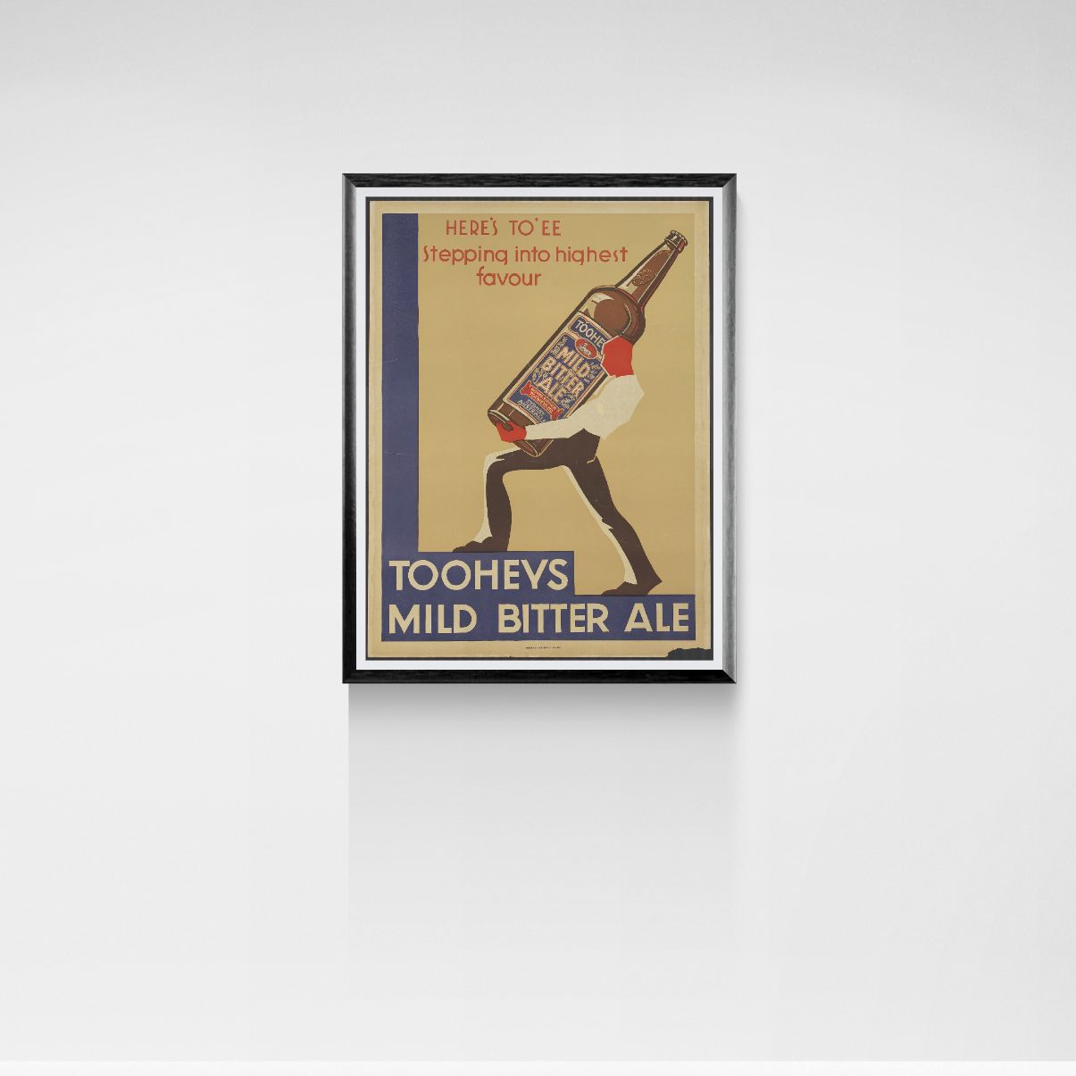 Framed vintage-style advertisement for Tooheys Mild Bitter Ale on a white wall.