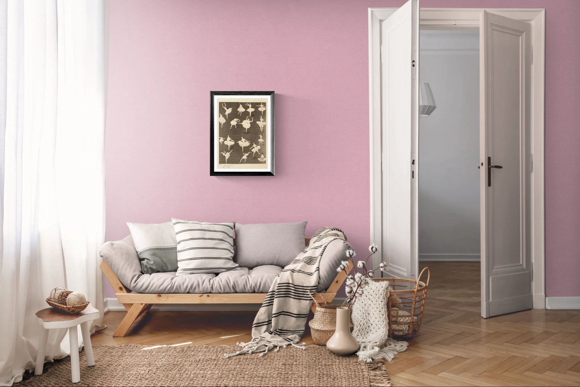 Living room with pink walls, a gray sofa, and decorative items.