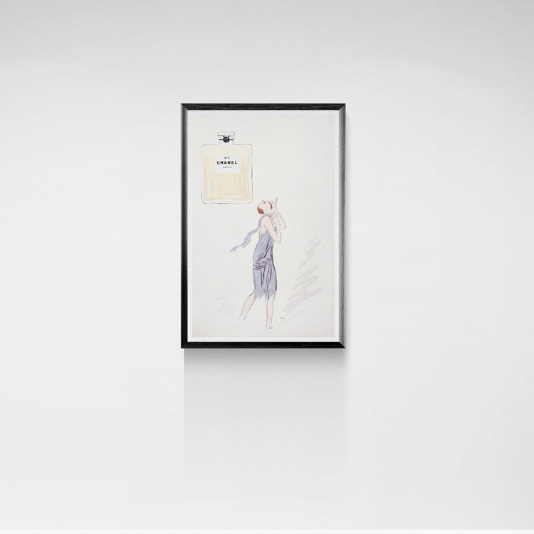 Framed artwork of a woman in a dress on a white wall