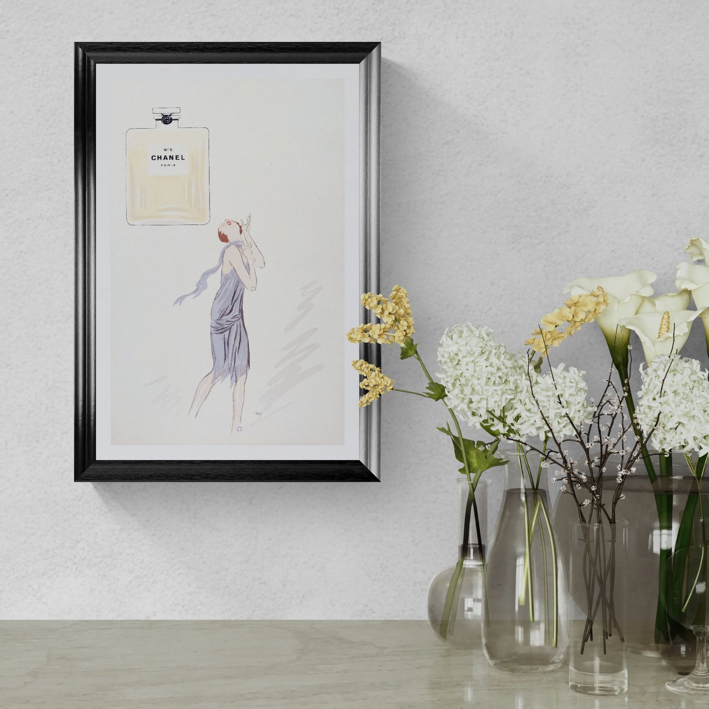 Framed artwork of a woman in a dress on a wall with vases of flowers below.