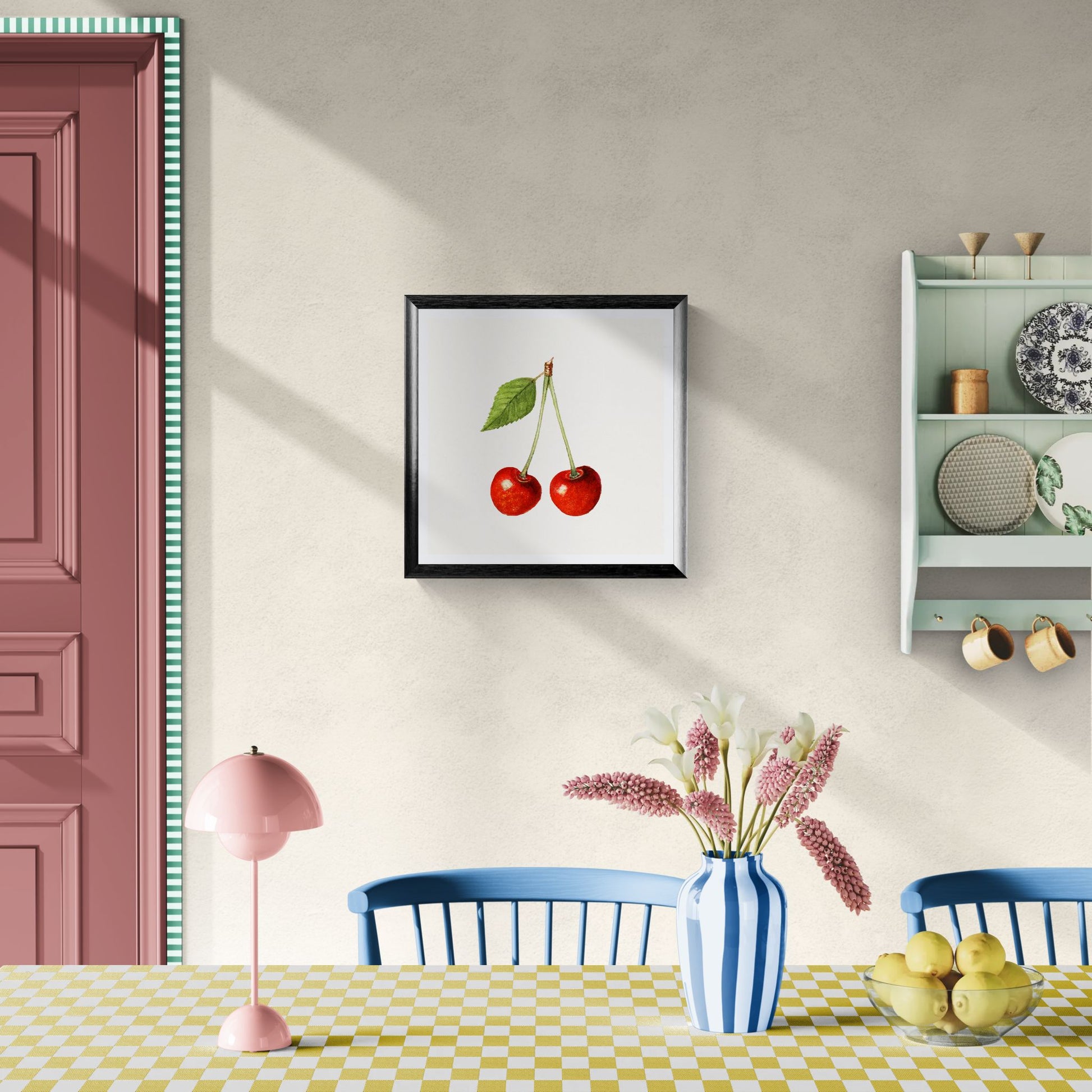Dining room with a framed picture of cherries, a pink lamp, and a checkered tablecloth.