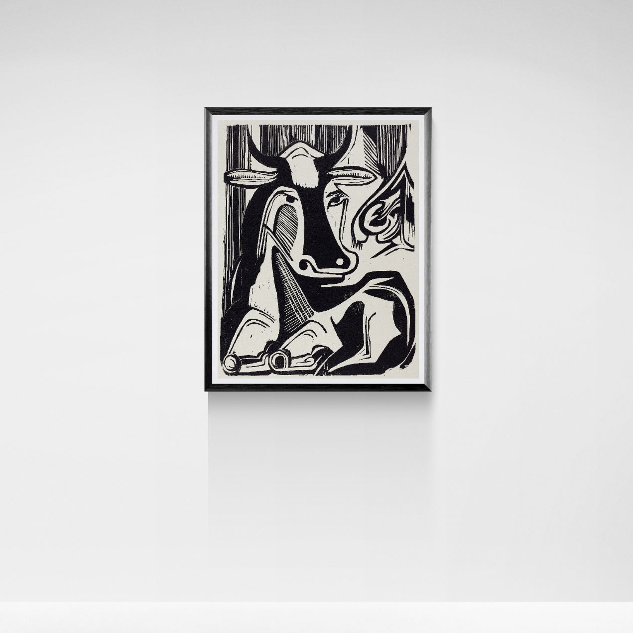 Framed black and white abstract artwork of a cow on a white wall