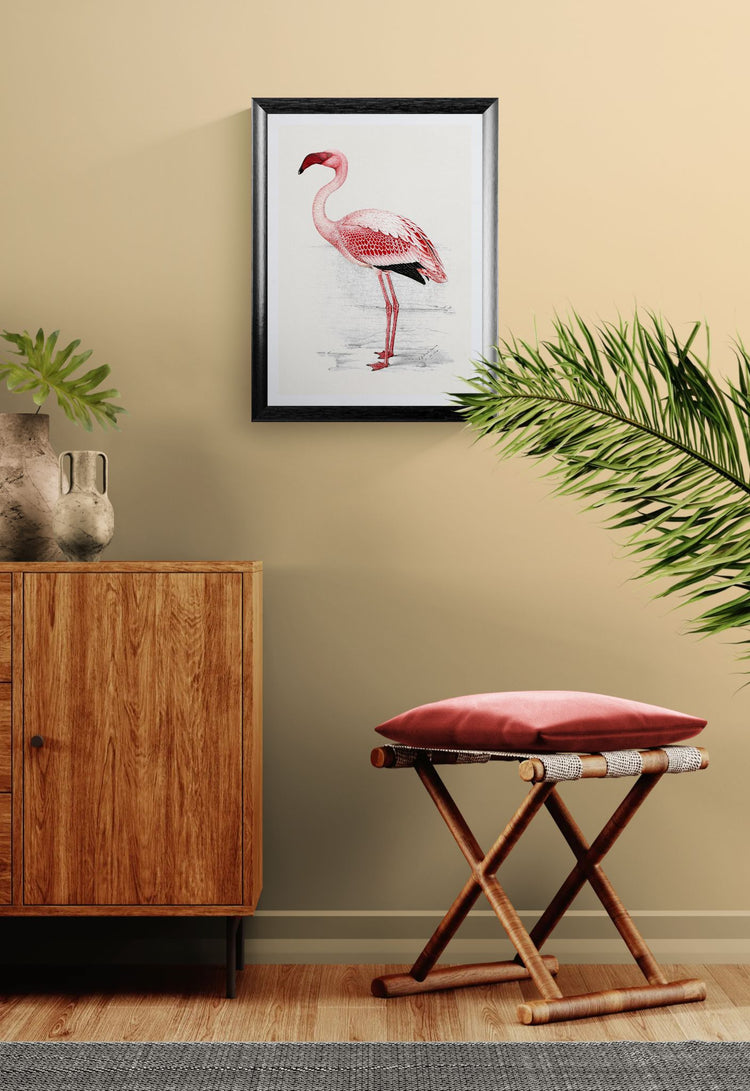 Flamingo artwork on a wall above a wooden cabinet with a red cushioned stool.