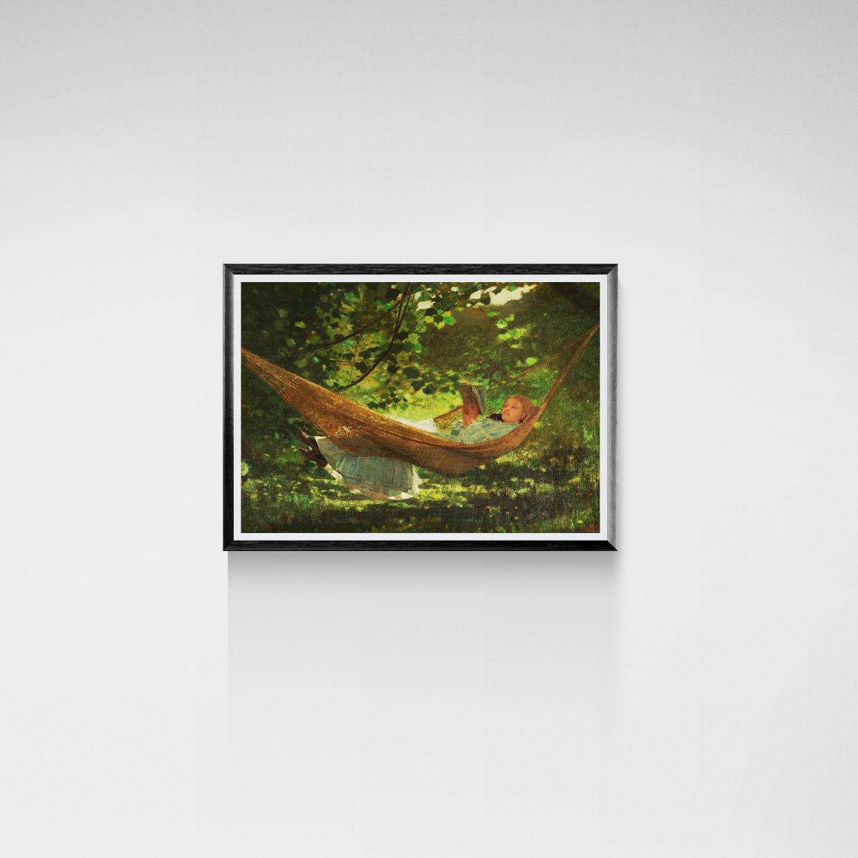 Framed artwork of a person in a hammock surrounded by greenery.