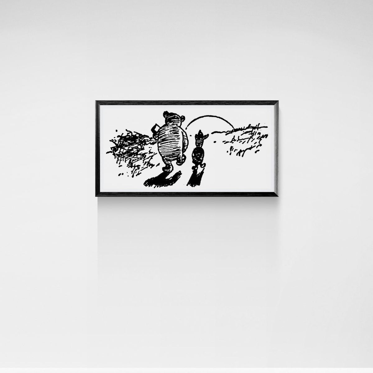 Framed black and white illustration of a bear and a piglet on a white wall